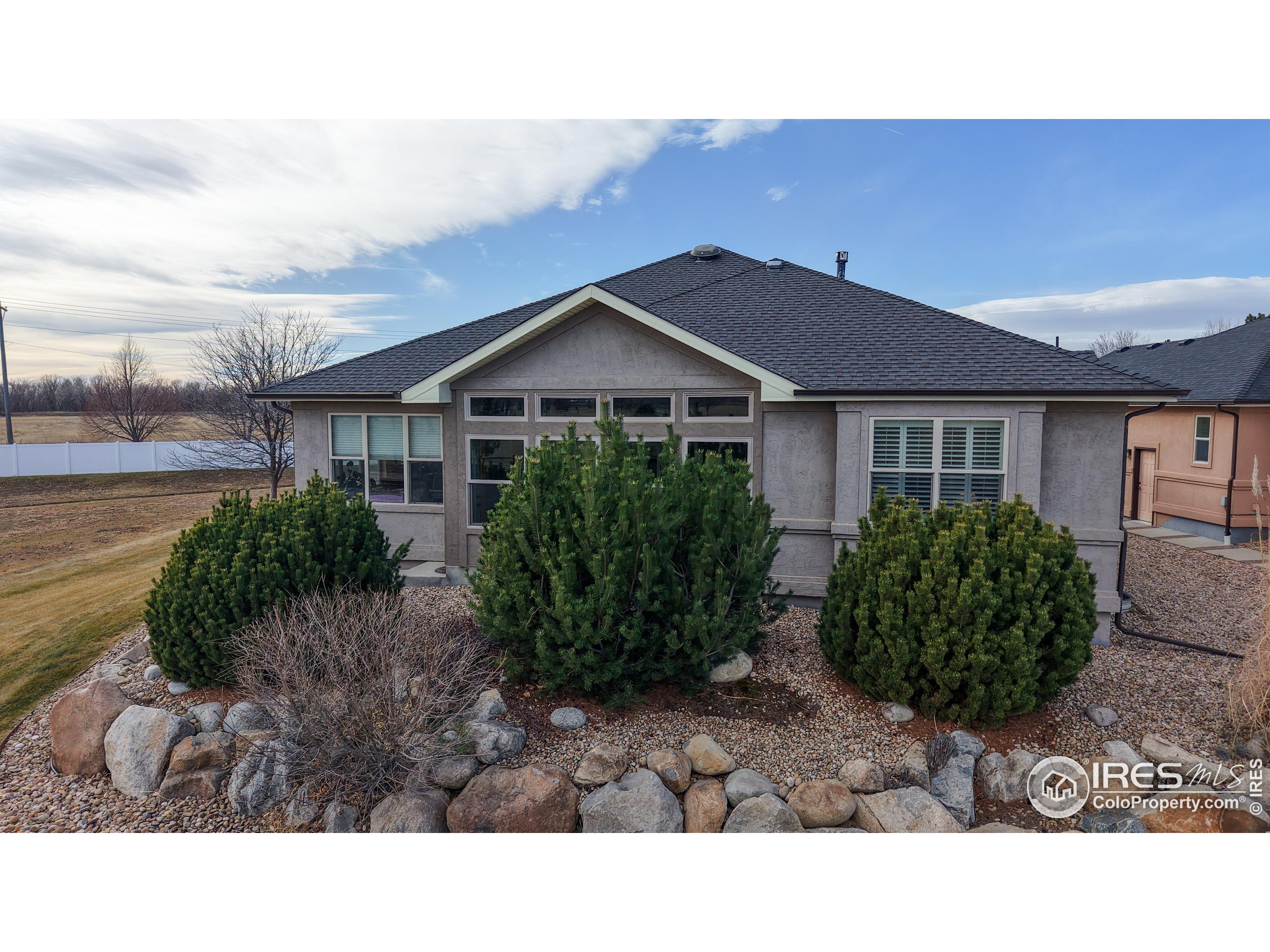 3602 Doral Place Longmont, CO 80503 - Photo 33 of 40 a black and white house with a yard
