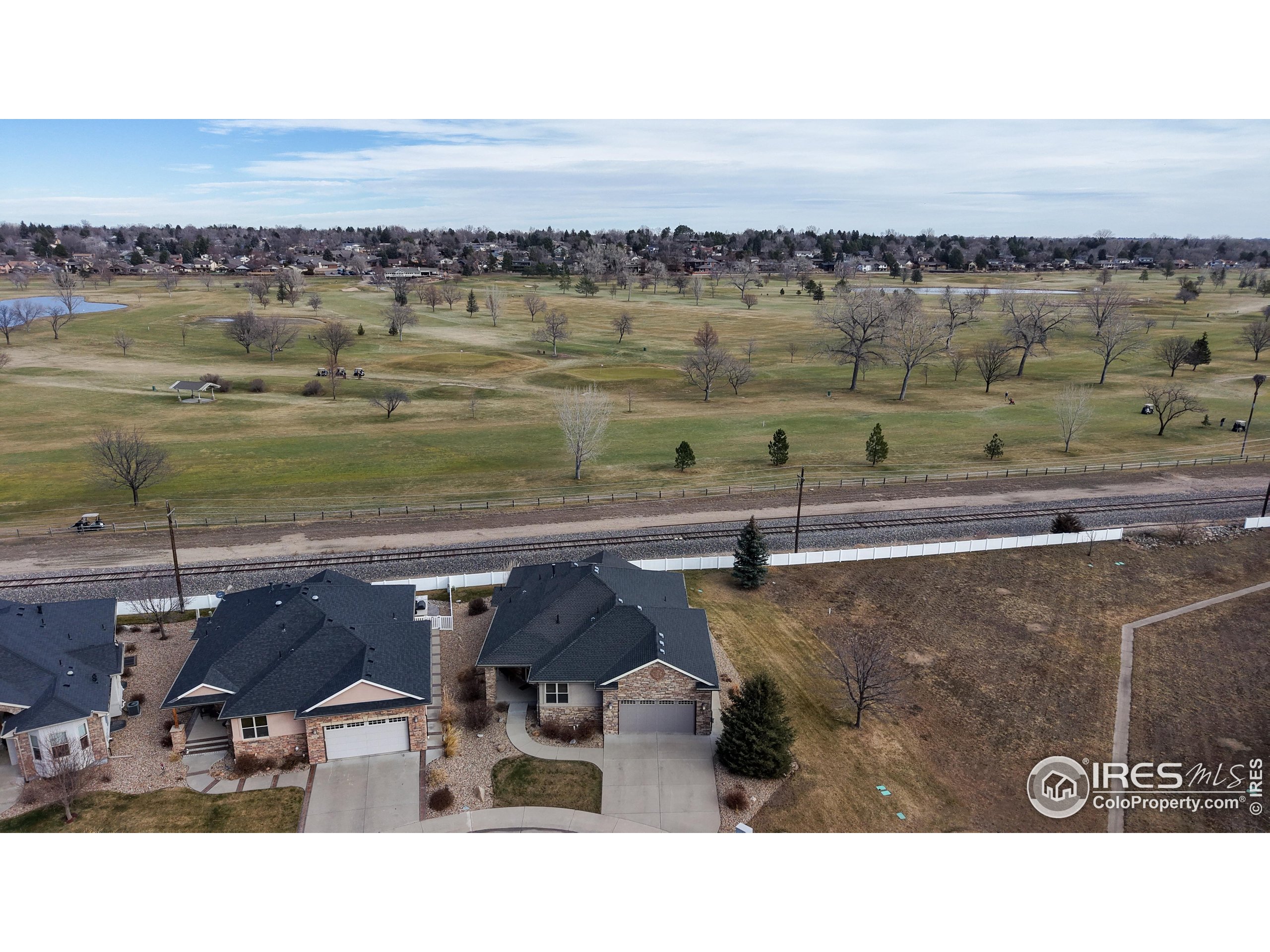 3602 Doral Place Longmont, CO 80503 - Photo 37 of 40 a view of a lake with a yard