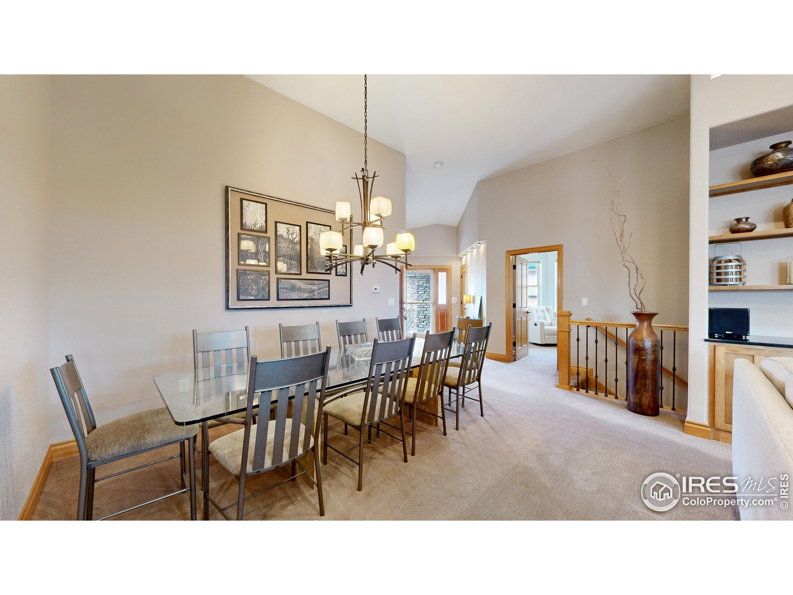 3602 Doral Place Longmont, CO 80503 - Photo 4 of 40 a dining room with furniture and a painting on the wall
