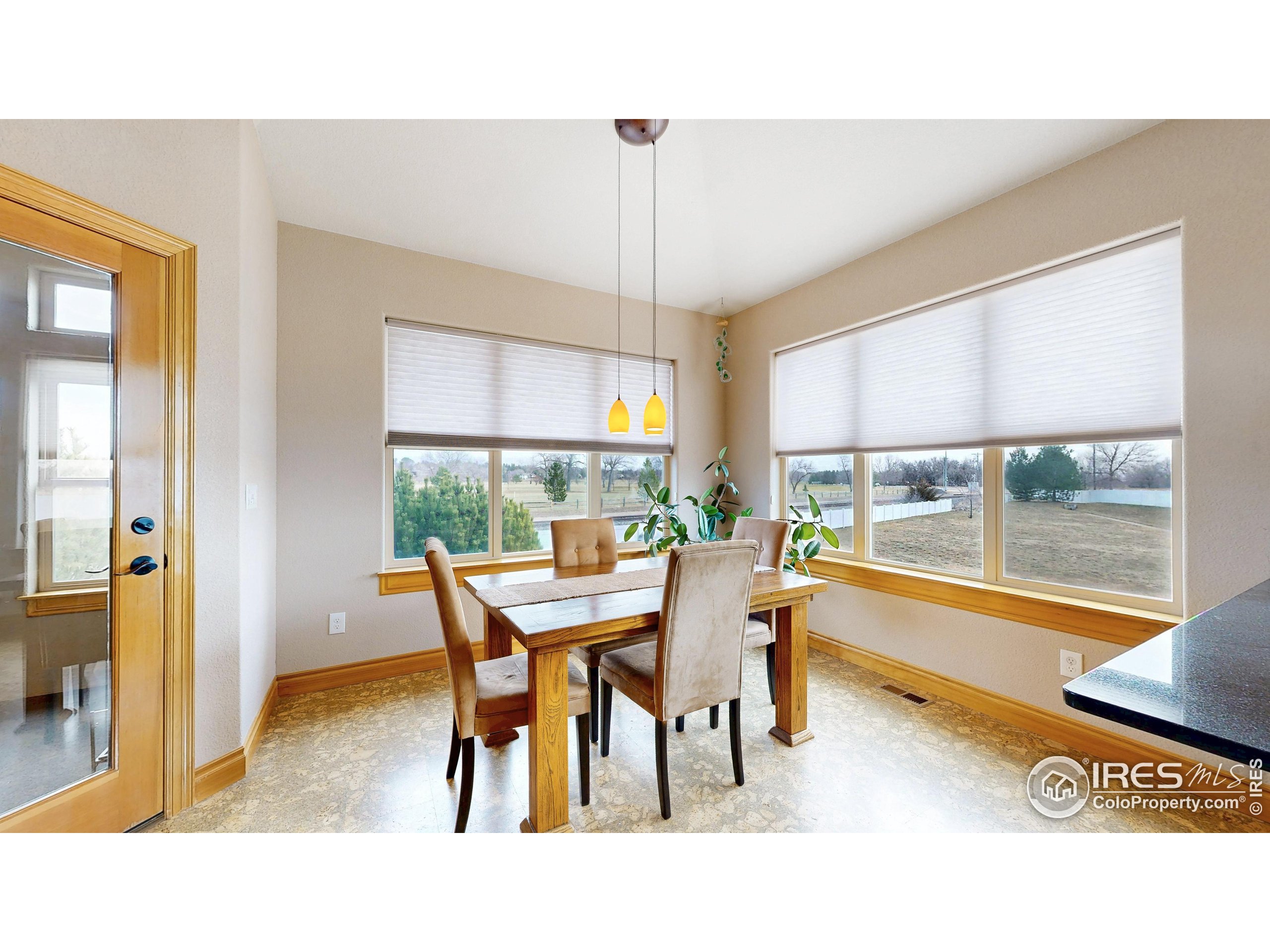 3602 Doral Place Longmont, CO 80503 - Photo 8 of 40 a dining room with a table and chairs