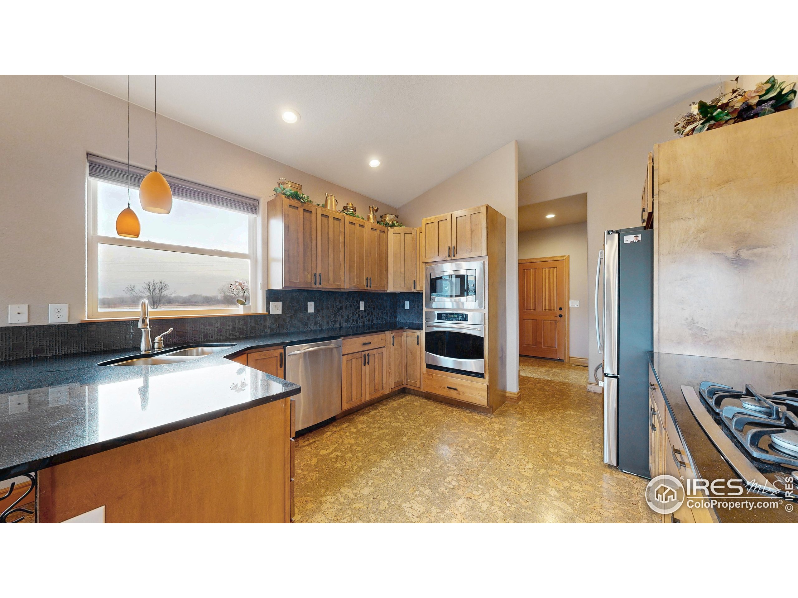 3602 Doral Place Longmont, CO 80503 - Photo 10 of 40 a kitchen with stainless steel appliances granite countertop a sink refrigerator and cabinets