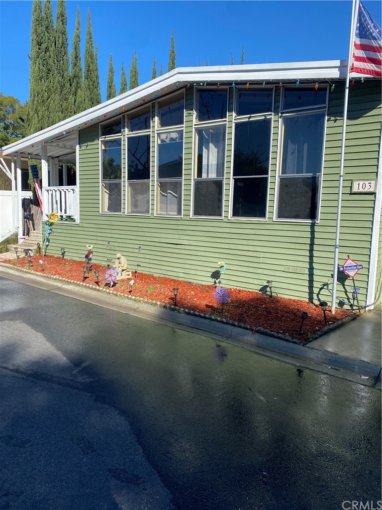 a front view of a house with a garden