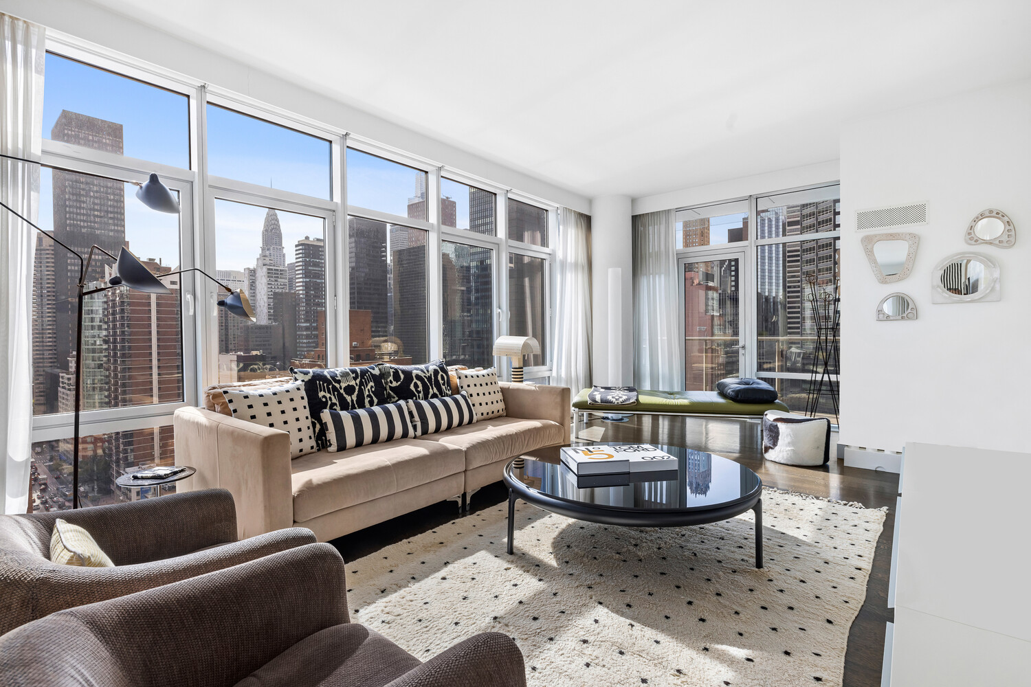 310 East 53rd Street, Unit 21C Manhattan, NY 10022 - Photo 3 of 19 a living room with furniture and a large window