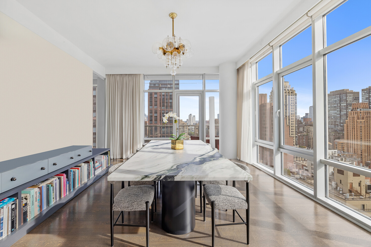 310 East 53rd Street, Unit 21C Manhattan, NY 10022 - Photo 4 of 19 a view of a dining room with furniture window and wooden floor