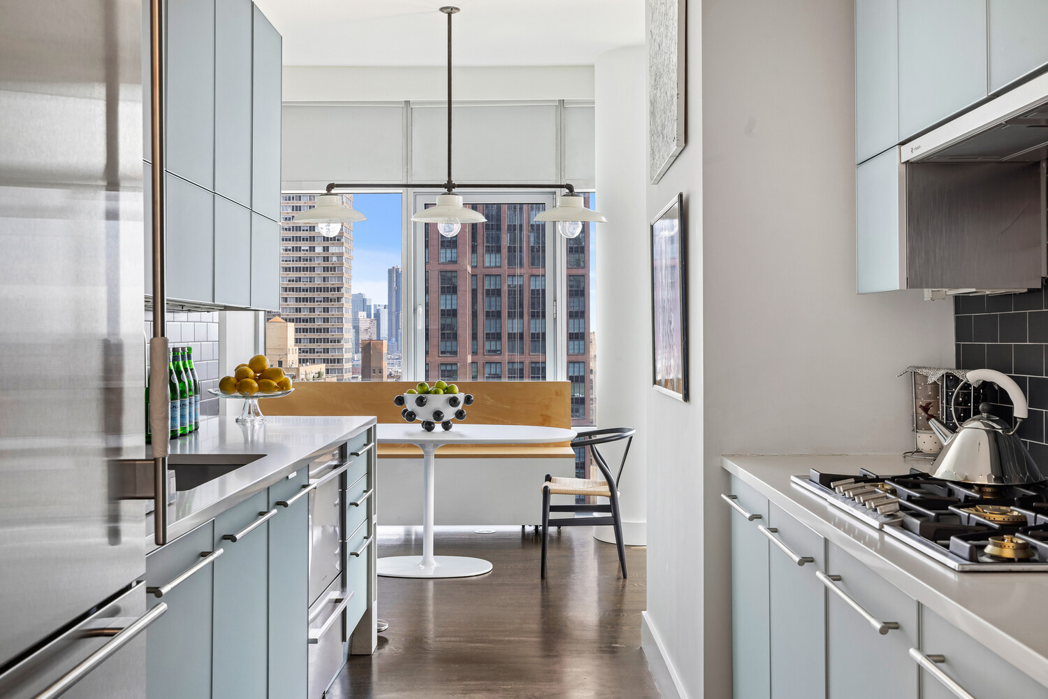 310 East 53rd Street, Unit 21C Manhattan, NY 10022 - Photo 6 of 19 a kitchen with a sink stove and cabinets