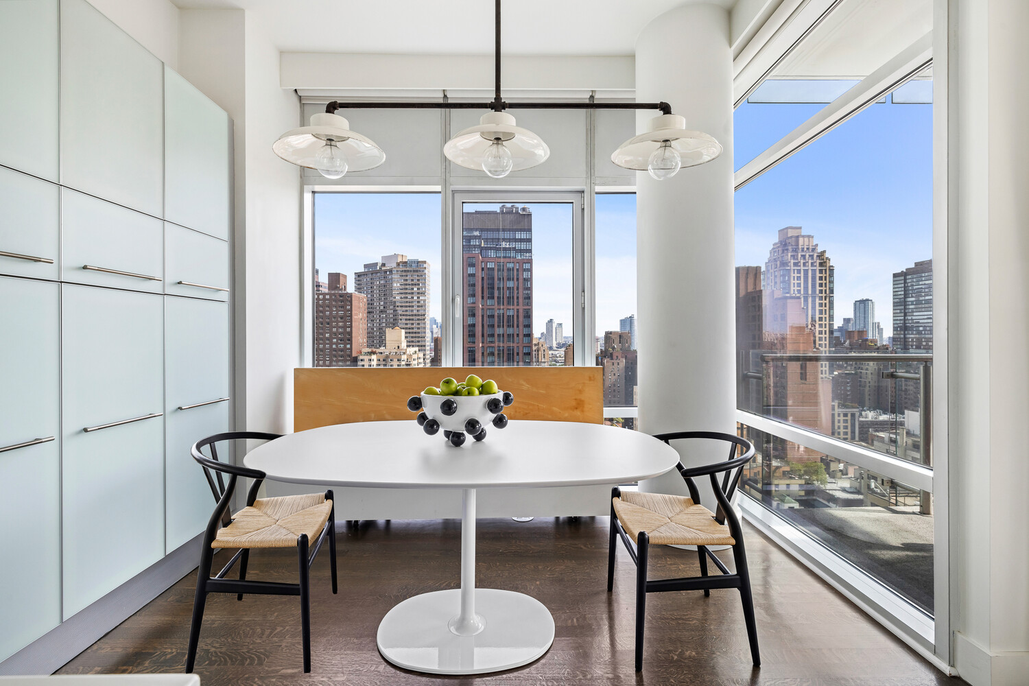 310 East 53rd Street, Unit 21C Manhattan, NY 10022 - Photo 7 of 19 a view of a dining room with furniture window and wooden floor