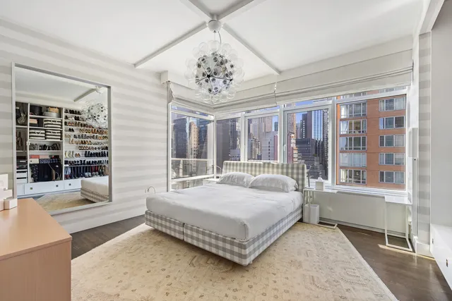 a bedroom with a large bed and a large window