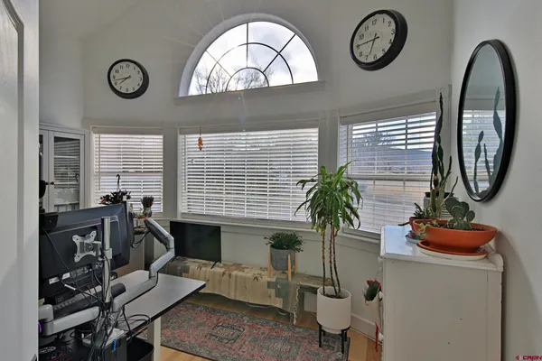 a view of a livingroom with furniture and a large window