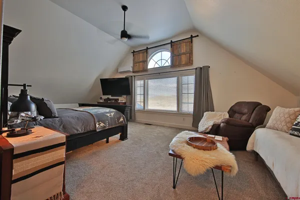 a bedroom with furniture and a window