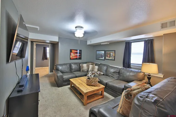 a living room with furniture and a lamp