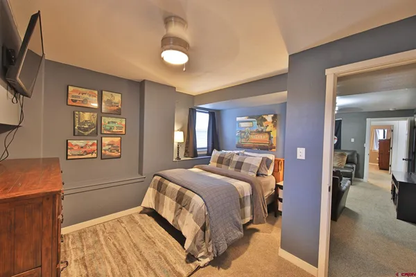 a bedroom with a bed and glass windows