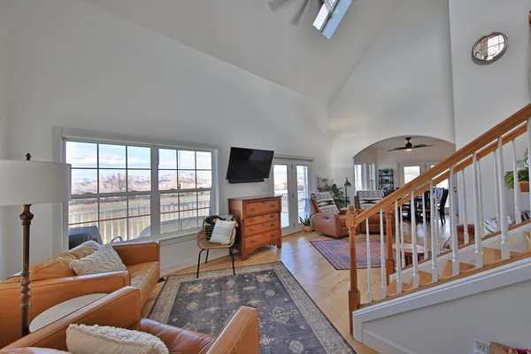 a living room with furniture or flat screen tv and a floor to ceiling window