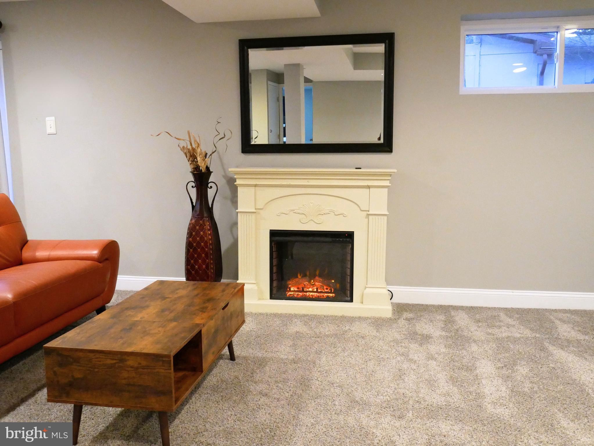 1805 Arcola Avenue, Unit A Silver Spring, MD 20902 - Photo 12 of 29 a living room with furniture a fireplace and a flat screen tv