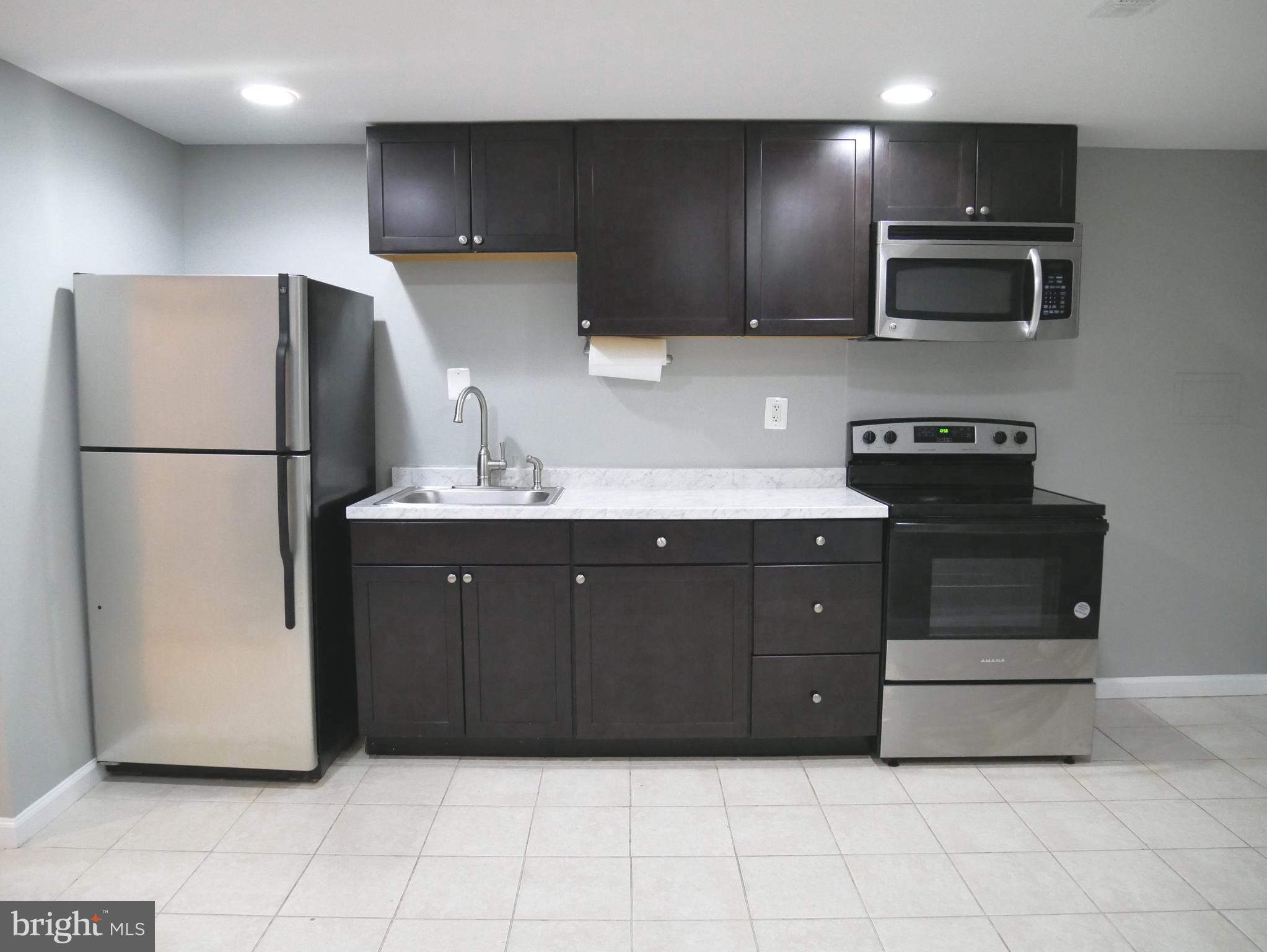 1805 Arcola Avenue, Unit A Silver Spring, MD 20902 - Photo 16 of 29 a kitchen with a refrigerator and a stove