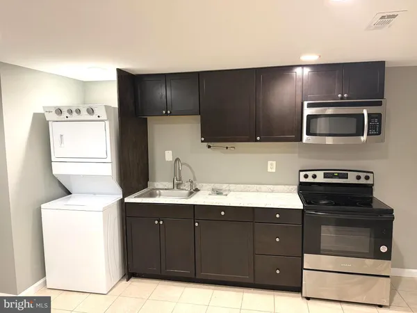 a kitchen with a sink and a stove top oven