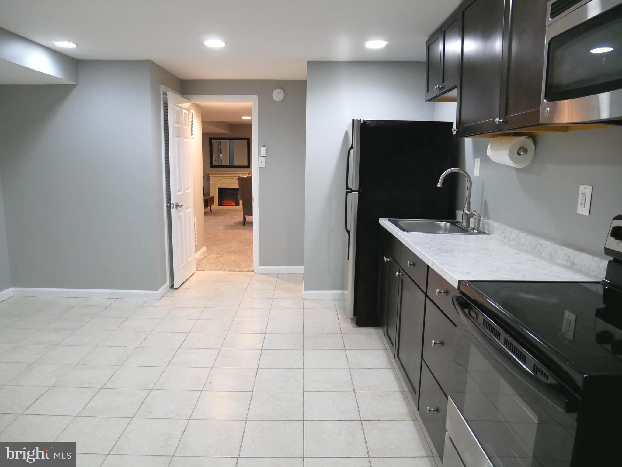 1805 Arcola Avenue, Unit A Silver Spring, MD 20902 - Photo 17 of 29 a kitchen with stainless steel appliances granite countertop a sink and a refrigerator