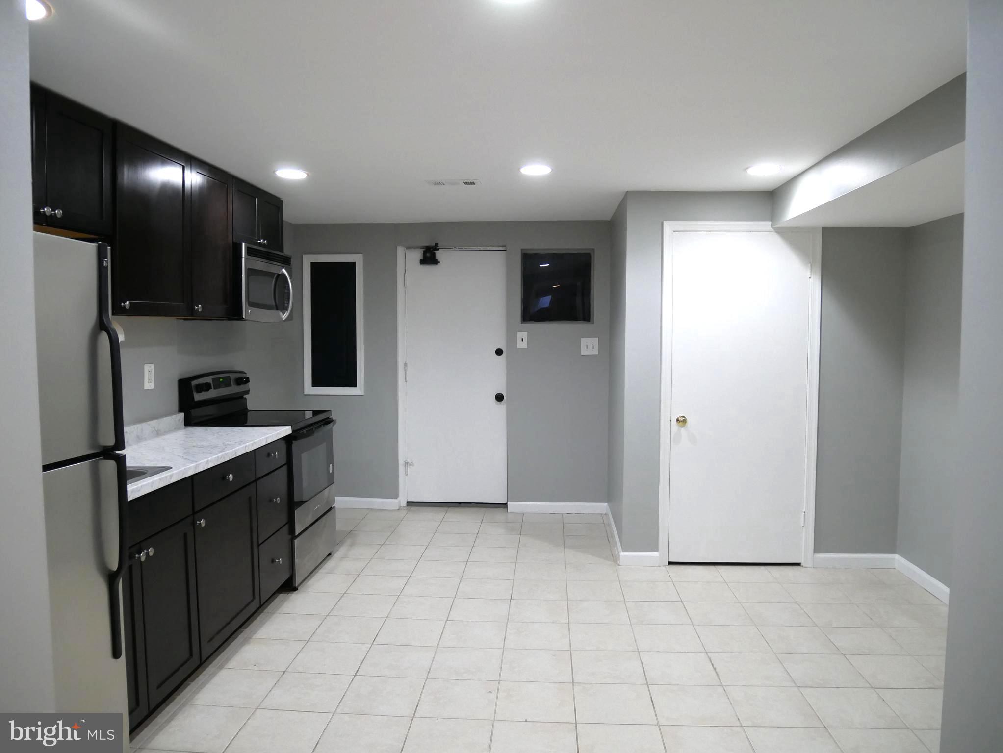 1805 Arcola Avenue, Unit A Silver Spring, MD 20902 - Photo 18 of 29 a kitchen with stainless steel appliances granite countertop a refrigerator and a sink