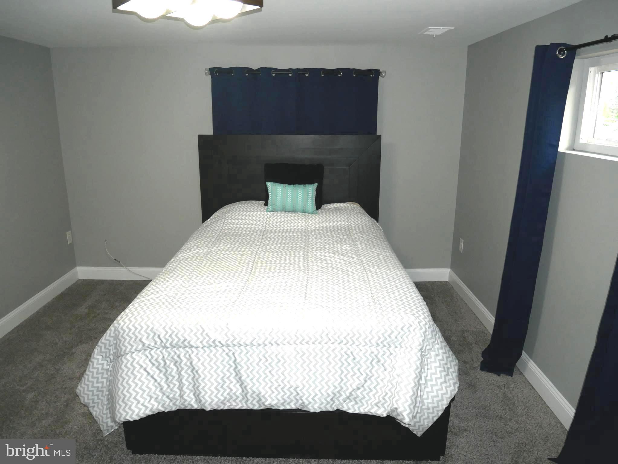 1805 Arcola Avenue, Unit A Silver Spring, MD 20902 - Photo 21 of 29 a bedroom with a bed and window
