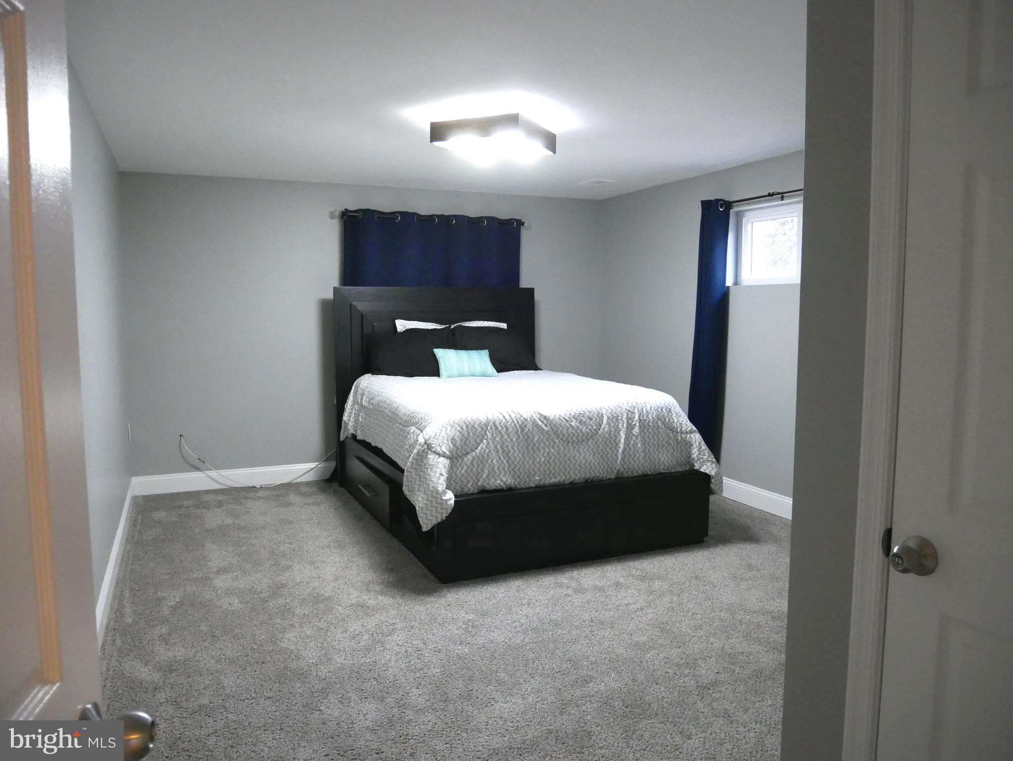 1805 Arcola Avenue, Unit A Silver Spring, MD 20902 - Photo 22 of 29 a bedroom with a bed and window
