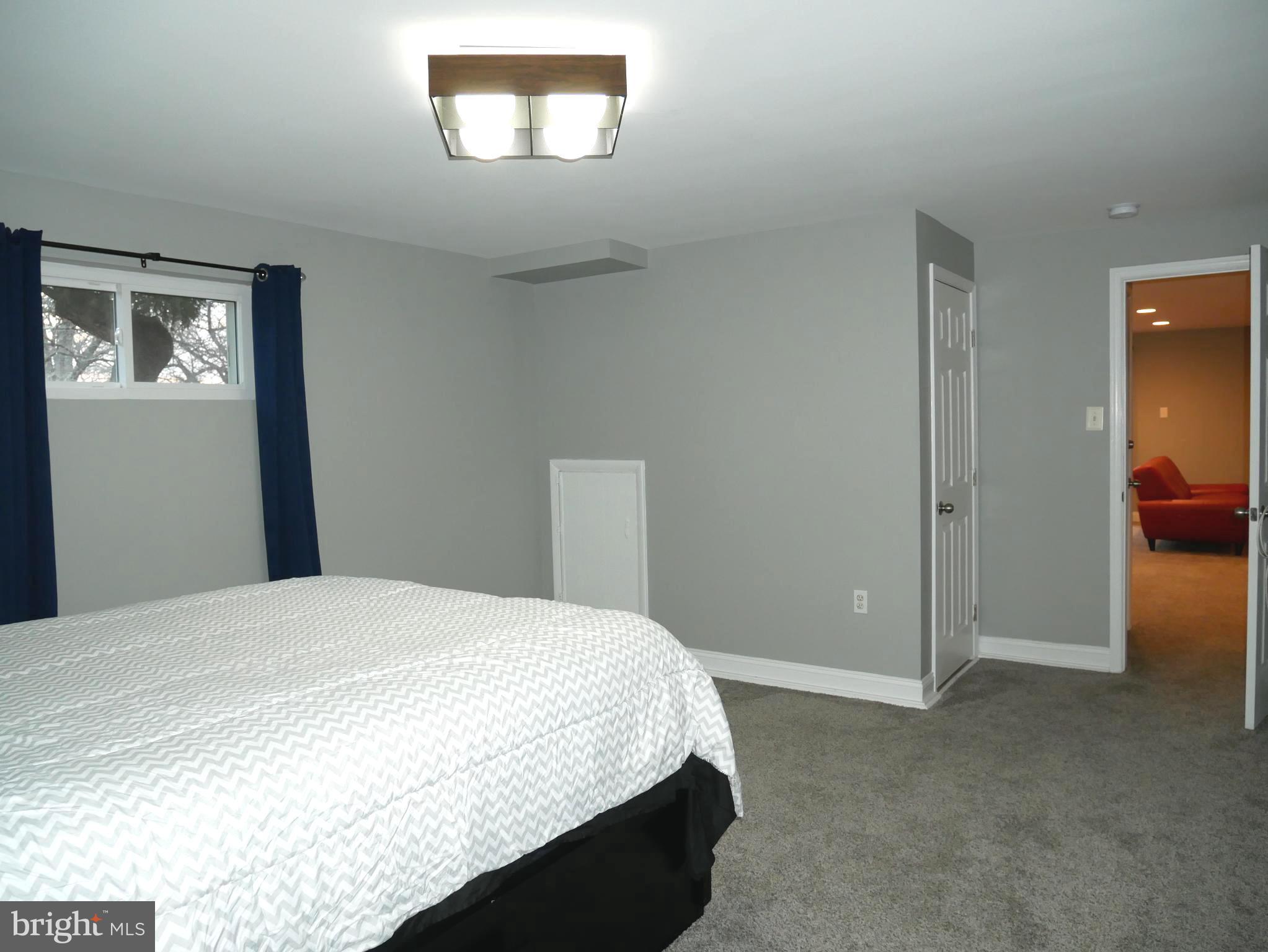 1805 Arcola Avenue, Unit A Silver Spring, MD 20902 - Photo 24 of 29 a bedroom with a bed and a view of bathroom