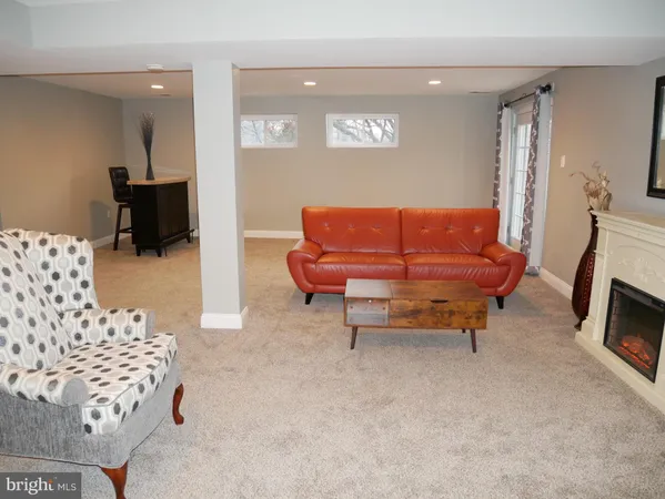 a living room with furniture a couch and a flat screen tv