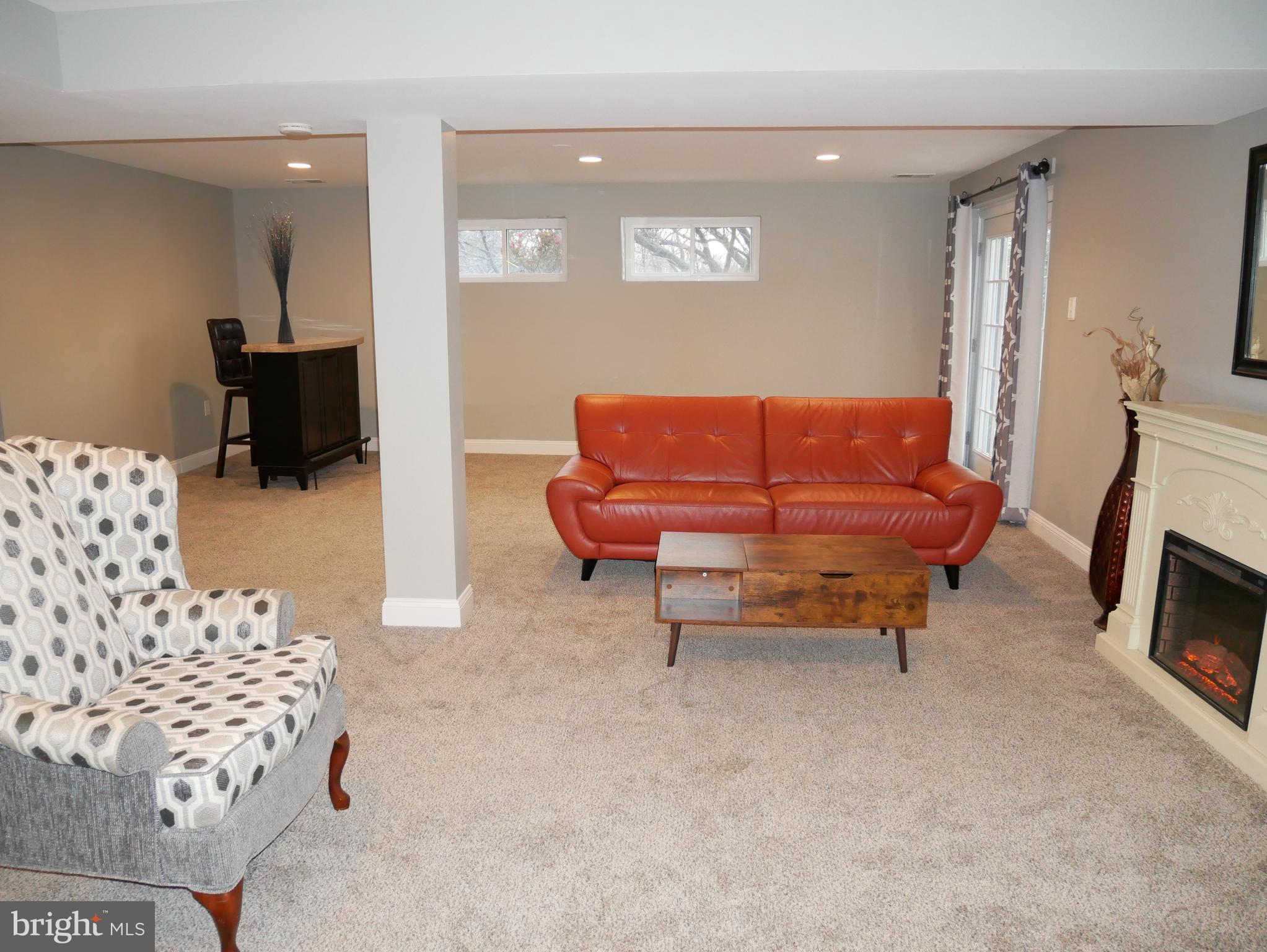 1805 Arcola Avenue, Unit A Silver Spring, MD 20902 - Photo 10 of 29 a living room with furniture a couch and a flat screen tv