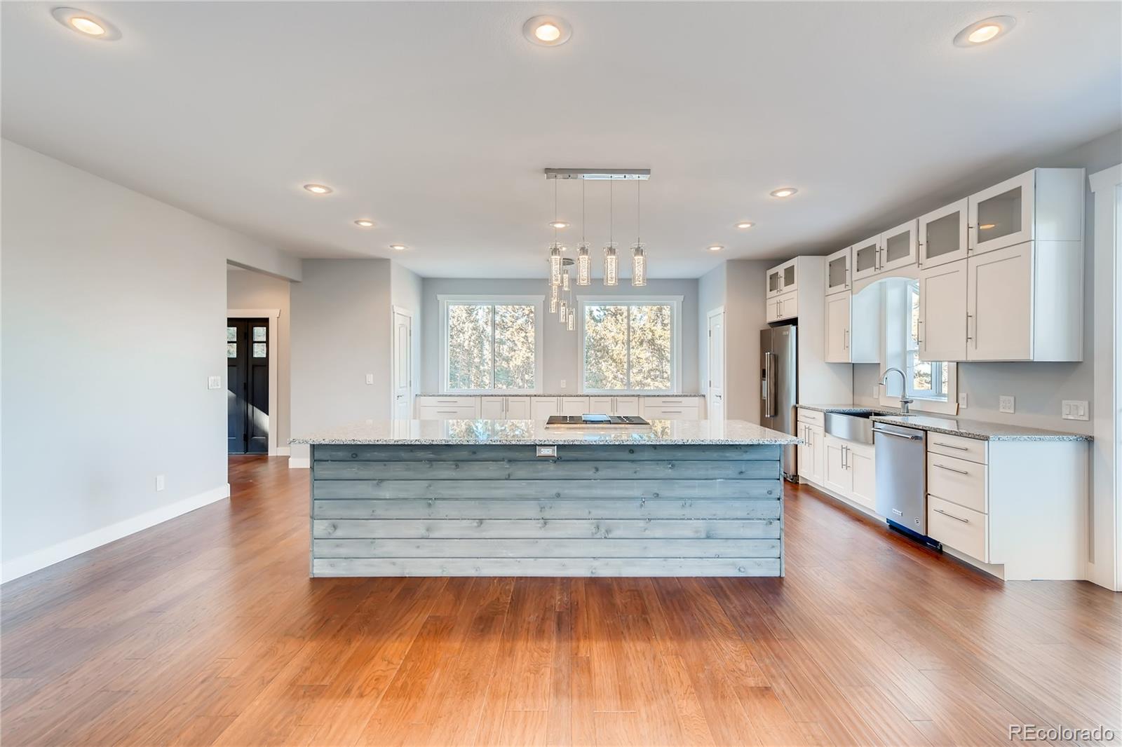 5967 High Drive Morrison, CO 80465 - Photo 11 of 38 a view of a kitchen with kitchen island a sink wooden floor and stainless steel appliances