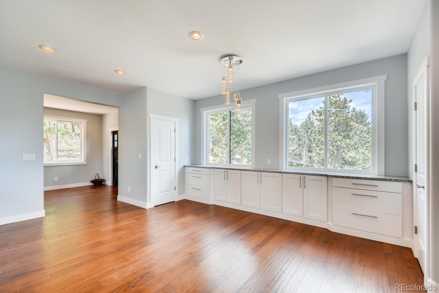 5967 High Drive Morrison, CO 80465 - Photo 13 of 38 an empty room with wooden floor and windows