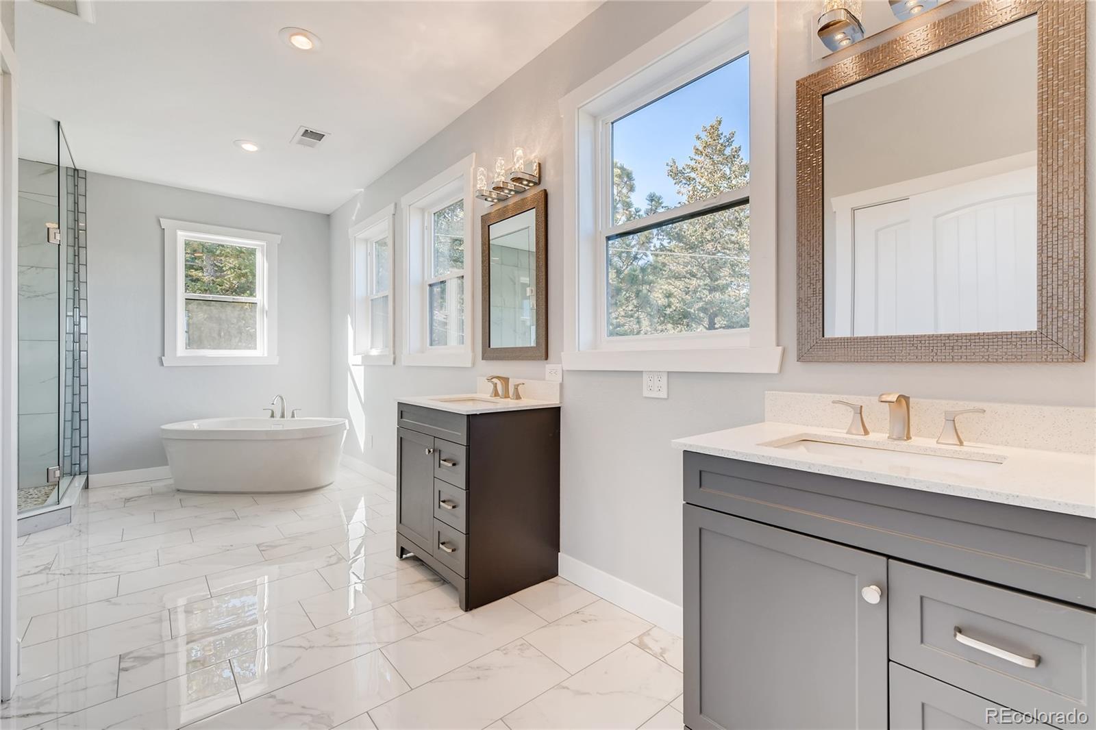 5967 High Drive Morrison, CO 80465 - Photo 21 of 38 a spacious bathroom with a tub sink and mirror