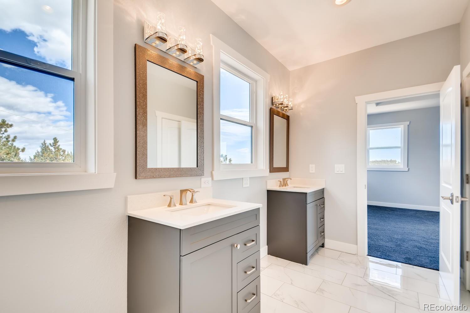5967 High Drive Morrison, CO 80465 - Photo 22 of 38 a bathroom with a double vanity sink mirror and bathtub