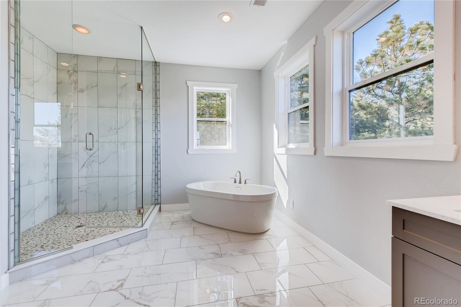 5967 High Drive Morrison, CO 80465 - Photo 23 of 38 a bathroom with a bathtub shower sink and mirror