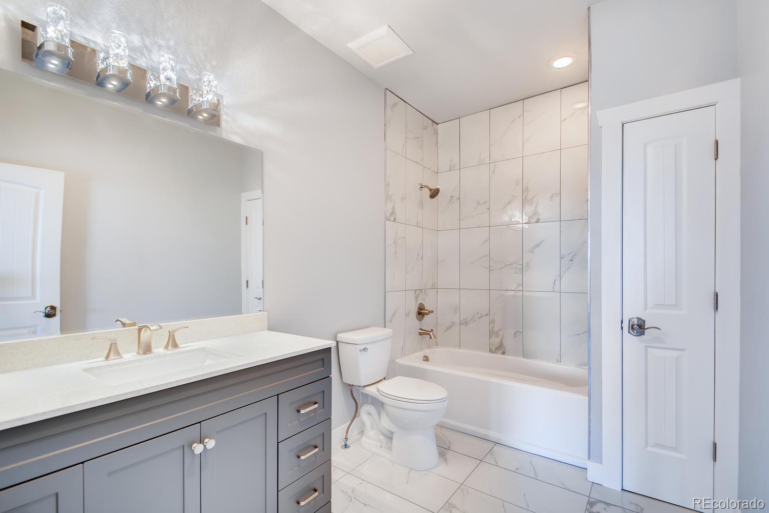 5967 High Drive Morrison, CO 80465 - Photo 28 of 38 a bathroom with a sink a toilet and shower