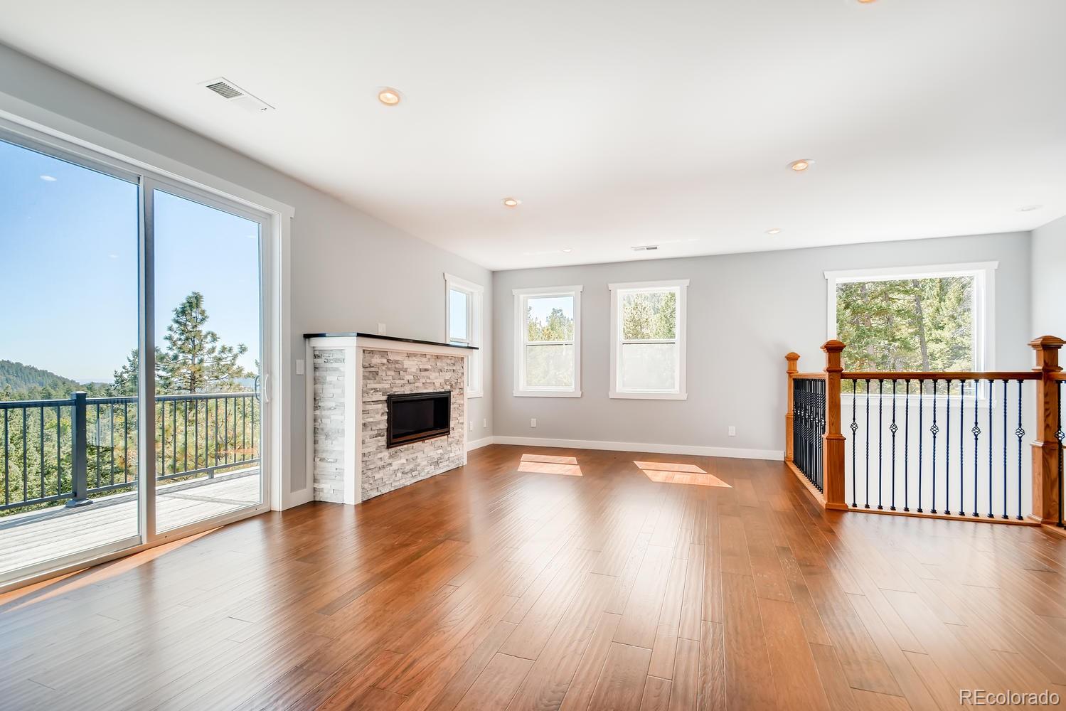 5967 High Drive Morrison, CO 80465 - Photo 29 of 38 a view of a livingroom with wooden floor a fireplace and window