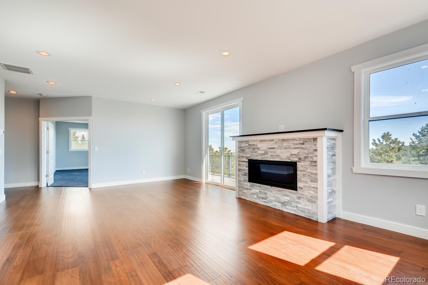 5967 High Drive Morrison, CO 80465 - Photo 30 of 38 a view of a livingroom with wooden floor and a fireplace