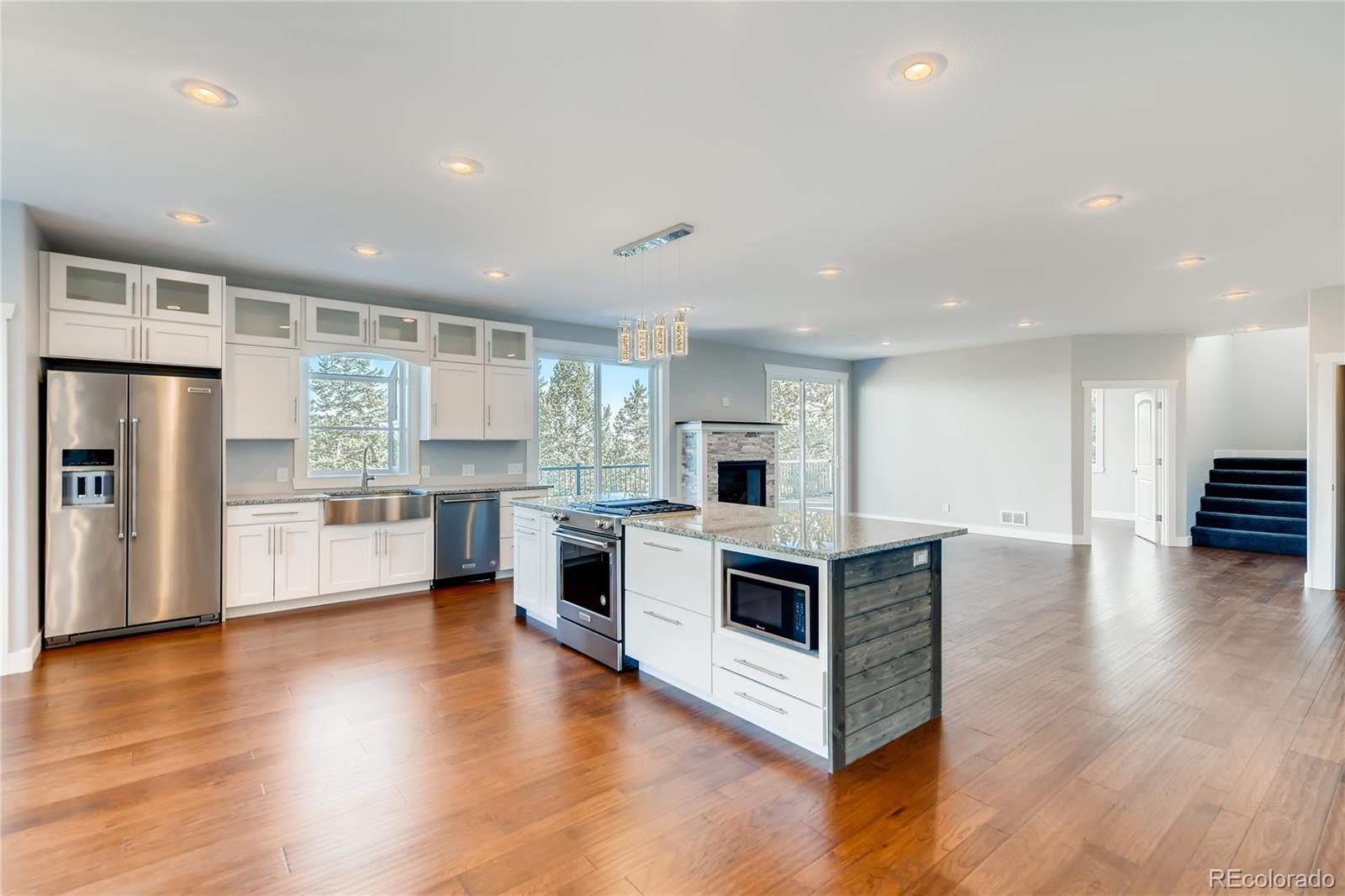 5967 High Drive Morrison, CO 80465 - Photo 5 of 38 a kitchen with stainless steel appliances a stove top oven and a refrigerator