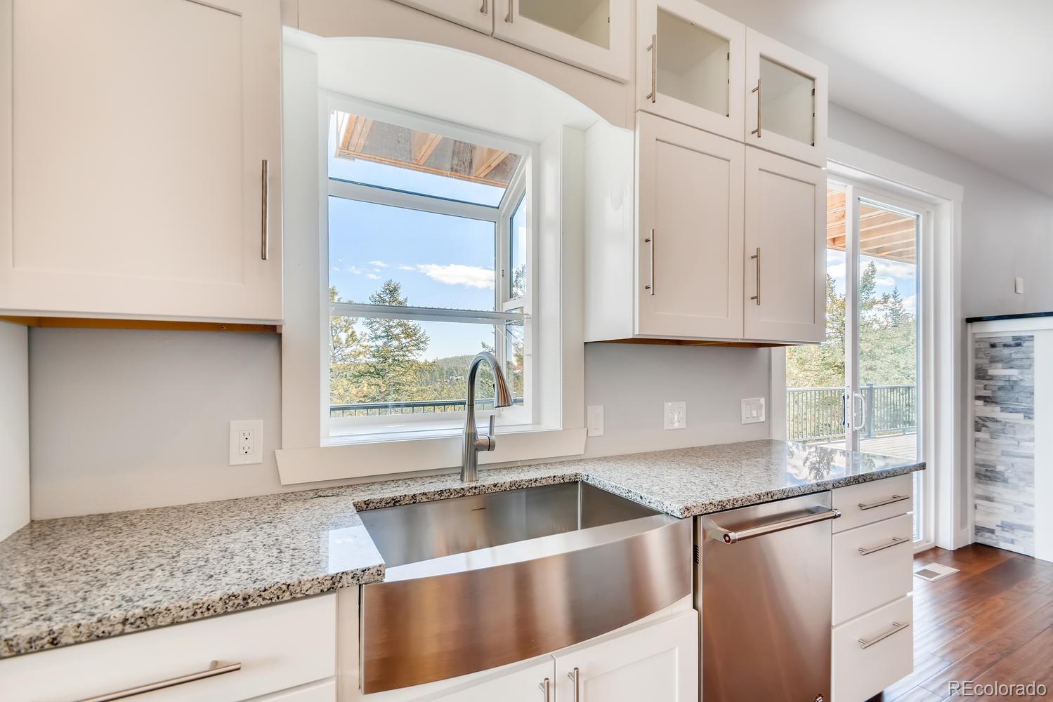 5967 High Drive Morrison, CO 80465 - Photo 8 of 38 a kitchen with stainless steel appliances granite countertop a sink and a white cabinets with wooden floor