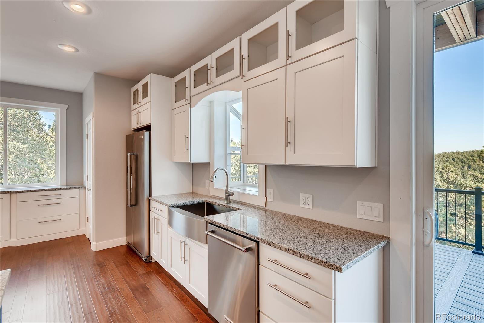 5967 High Drive Morrison, CO 80465 - Photo 9 of 38 a kitchen with stainless steel appliances granite countertop a refrigerator and a stove