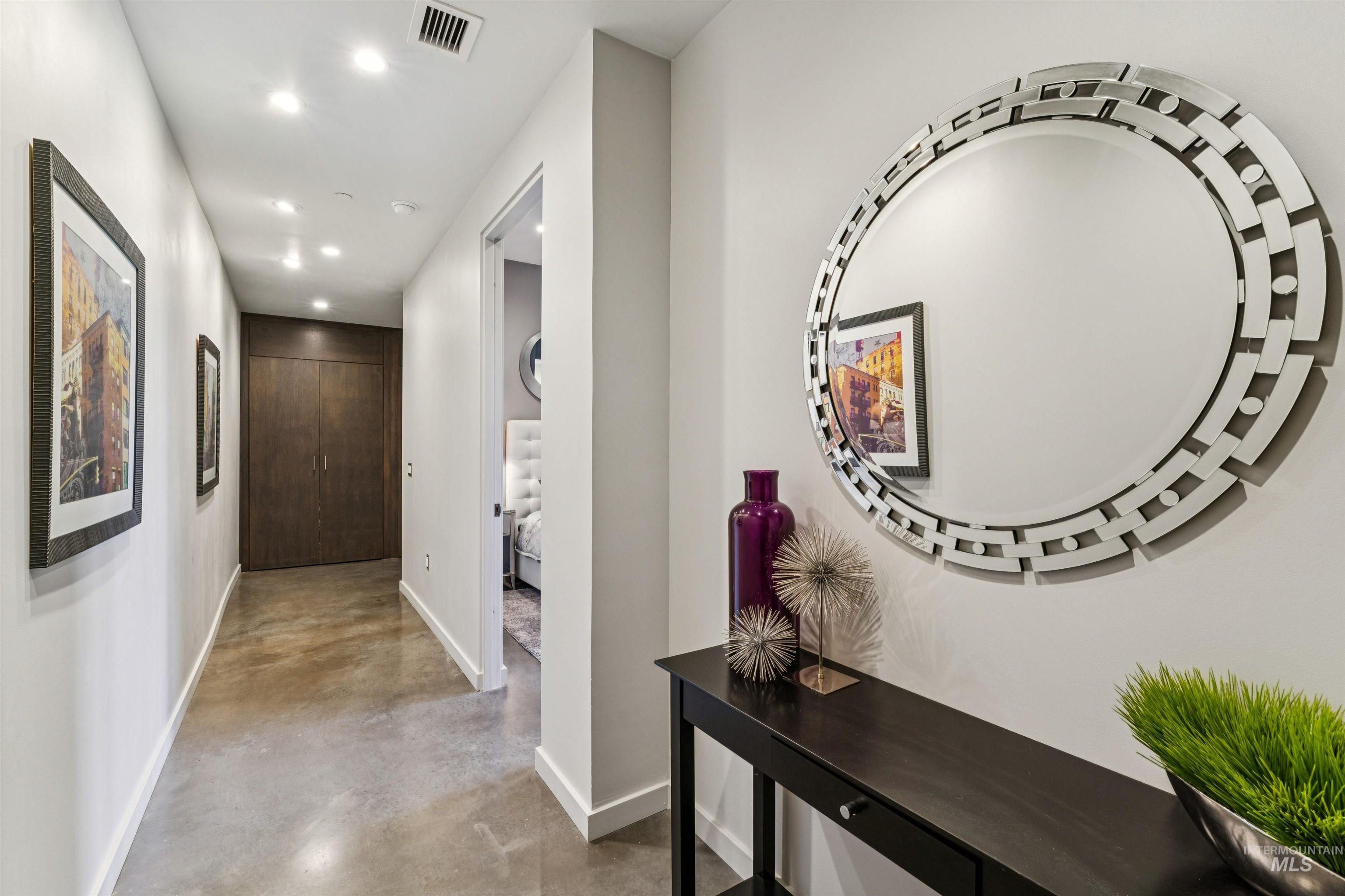 119 South 10th Street, Unit 307 Boise, ID 83702 - Photo 4 of 47 Hallway with polished concrete flooring, recessed lighting, and a built-in dark wood storage unit