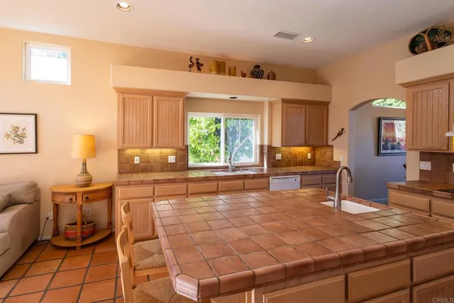 a kitchen with granite countertop a sink and a stove