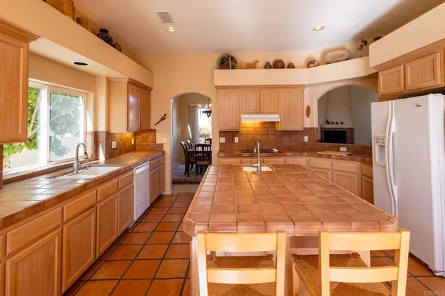 a large kitchen with lots of counter space and windows