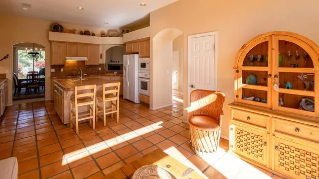 a living room with furniture a flat screen tv and kitchen view