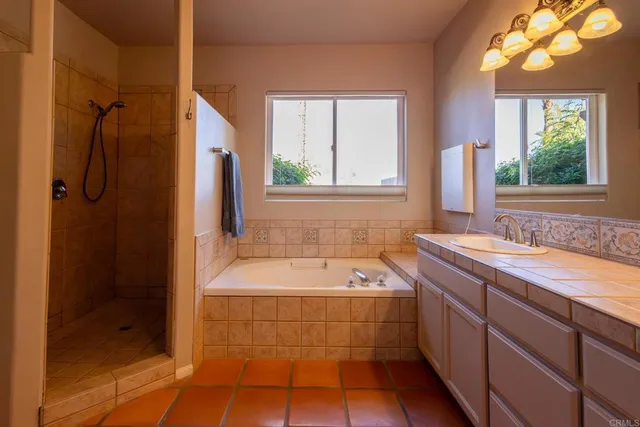 a bathroom with a tub sink and window