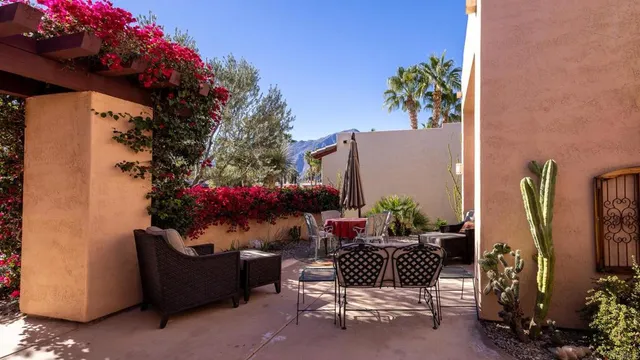 a view of a chairs and table in the patio