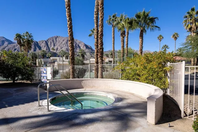 a view of a swimming pool with a patio and a yard
