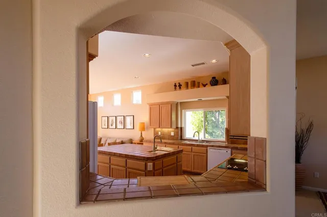 a living room with furniture a window and a dining table