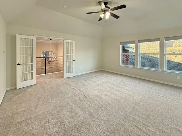 an empty room with windows and cabinet