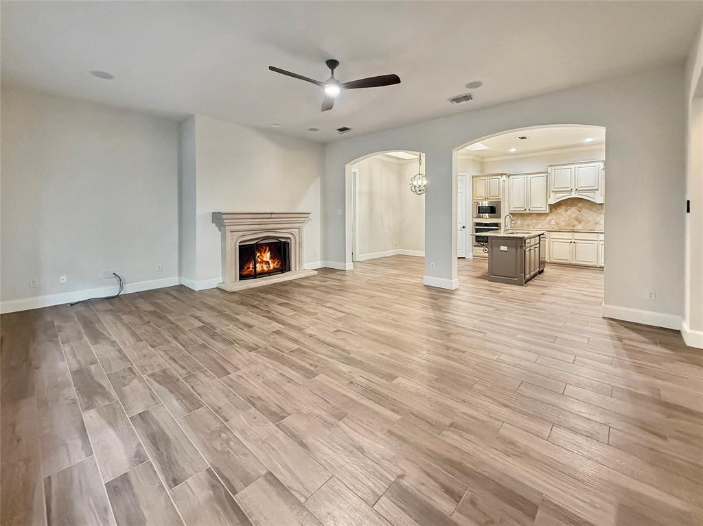 3779 Navarro Way Frisco, TX 75034 - Photo 3 of 17 a view of empty room with a fireplace and wooden floor