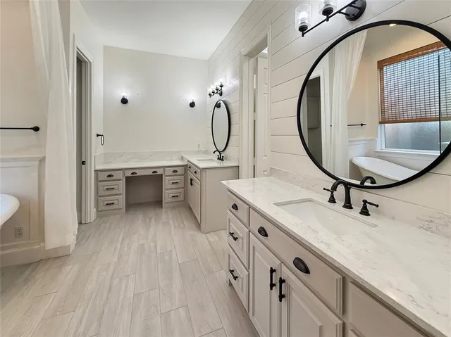 a spacious bathroom with a sink double vanity and a mirror