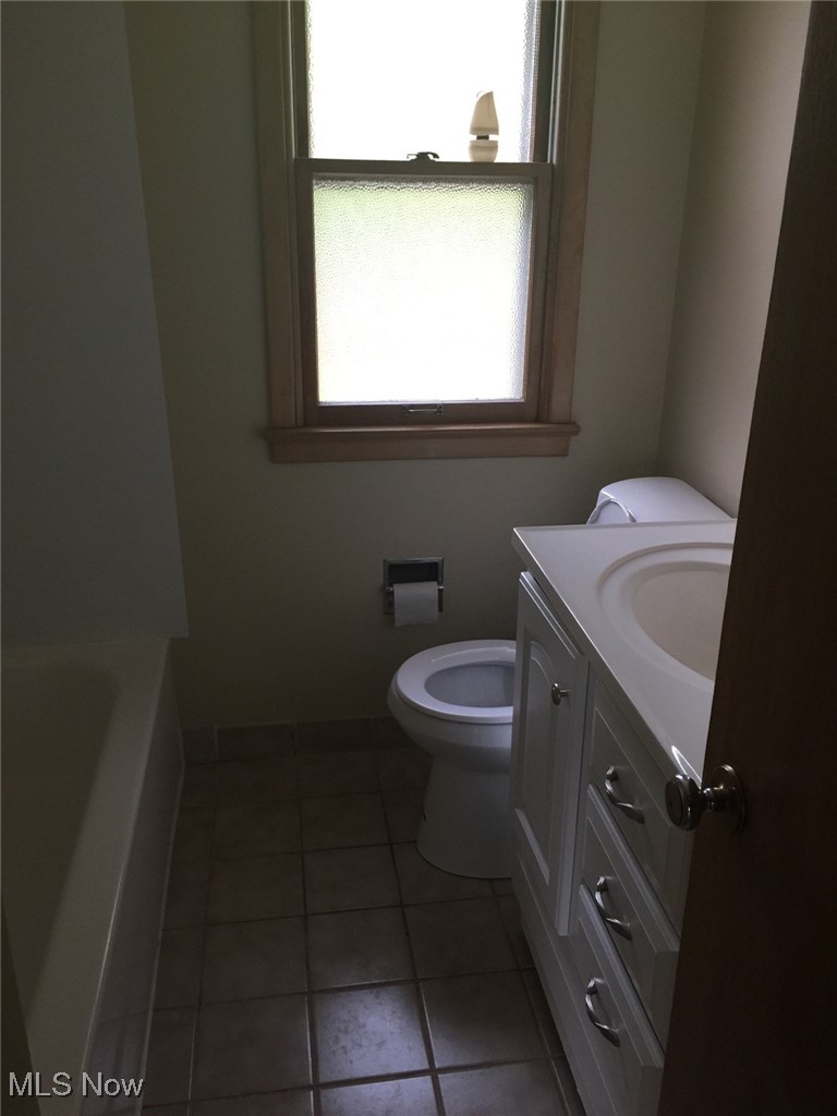 15860 Boston Road Strongsville, OH 44136 - Photo 7 of 7 Bathroom with a tub, toilet, vanity, and tile patterned flooring