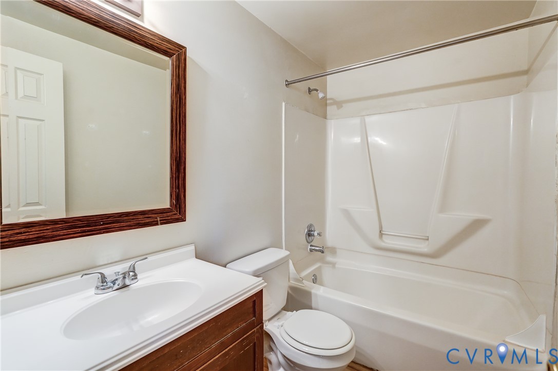 818 Spring Street Richmond, VA 23220 - Photo 21 of 28 a bathroom with a bathtub shower sink vanity mirror and toilet